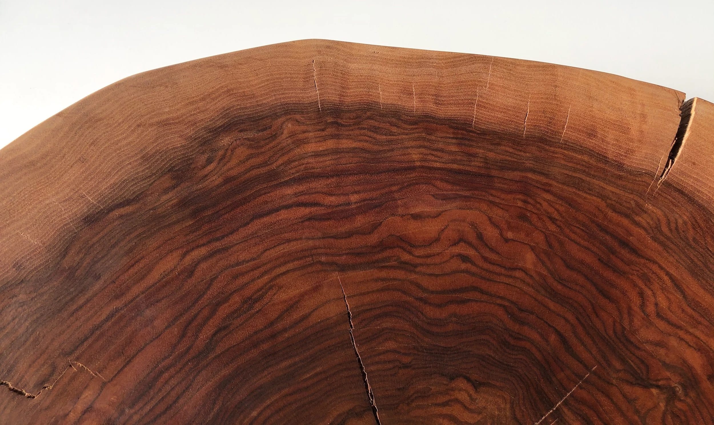Close-up of a wooden tree stump showing rich grain patterns